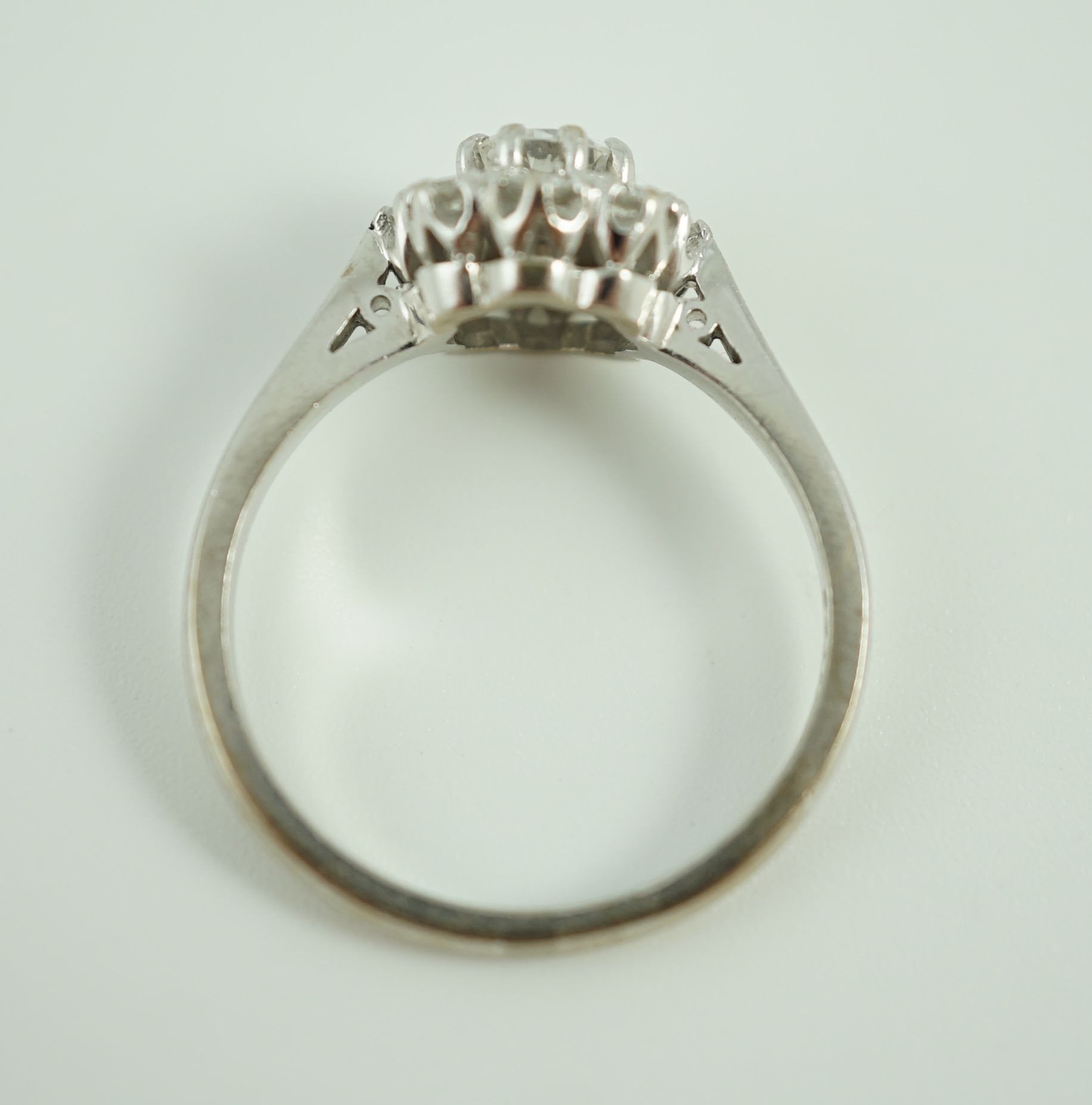 A modern 18ct white gold and nine stone diamond set flower head cluster ring